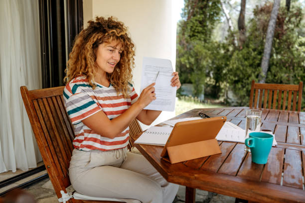 istock Smiling beautiful woman having video call on digital tablet while working from home 2199936264