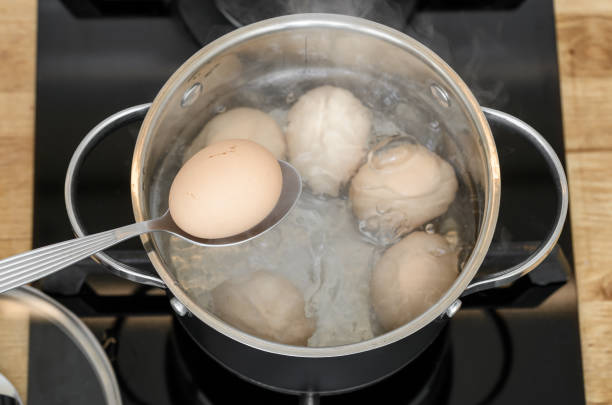 istock Place the egg in its shell into boiling water, cooking the egg until soft 2199939366