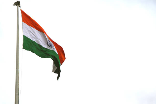 India flag flying high with pride in blue sky, India flag fluttering.