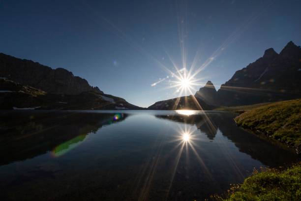 istock Sunrise over mountain lake with reflections. 2199948807