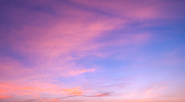 istock Sunset sky background with orange pink clouds on blue evening sky backdrop 2199949001