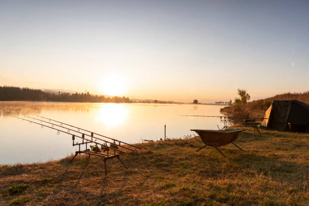 Man fishing on the mountain river at evening