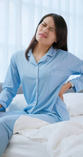 asian woman wakeup with backpain