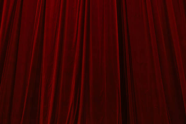 istock Red curtain in theatre background 2199965741