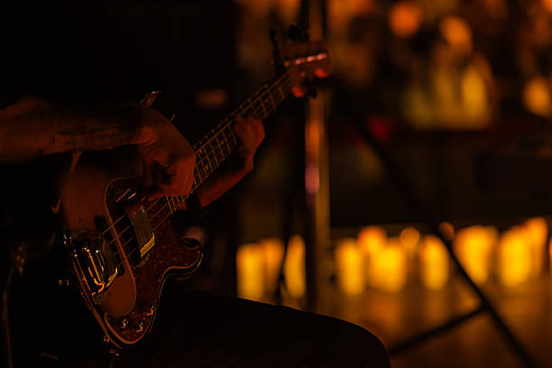 istock guitar player on concert stage with lots of candles 2199966448