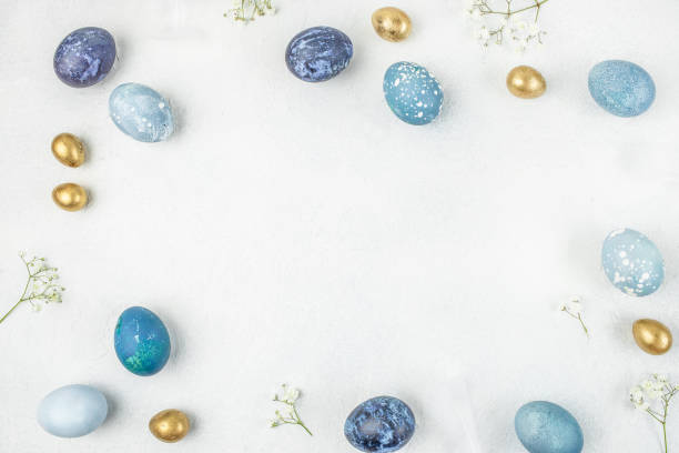 istock Happy Easter. Congratulatory easter background. Easter eggs and flowers on white background. top view. copy space 2199967581