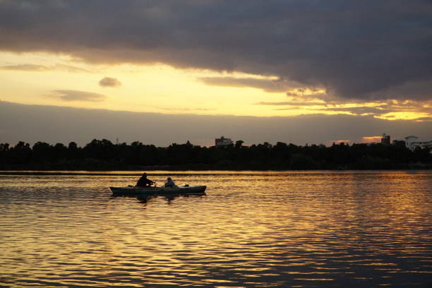 istock Fishermen rowing a small boat at sunset in the Crocodile lake 2199970020