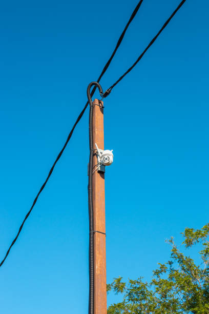 istock CCTV camera on a pole with electric wires. Security and surveillance of private territory 2199970129