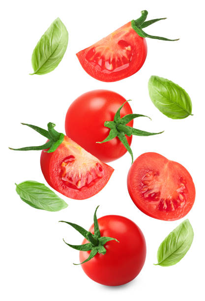 istock flying fresh tomatoes with green leaves isolated on white background. clipping path 2199970344