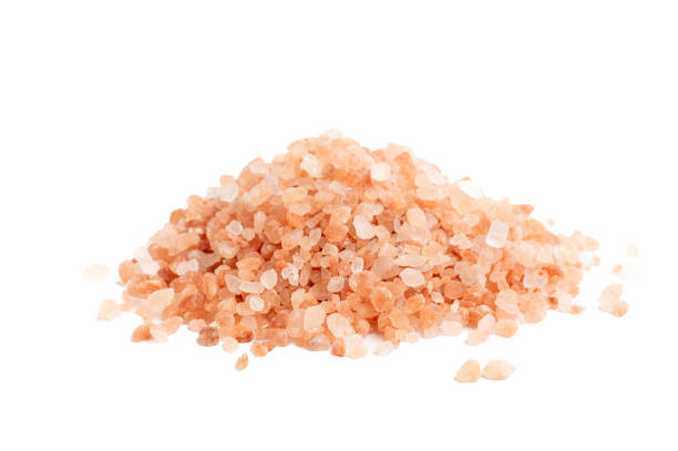 istock Pile of Himalayan pink salt crystals on white background 2199970525