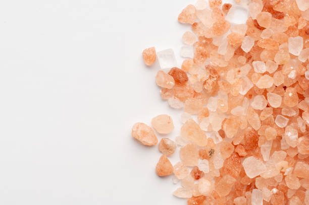 istock Scattered Himalayan pink salt crystals on white background 2199970531