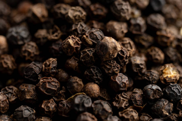 istock Close-up of black peppercorns texture 2199970635