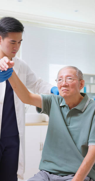 istock Asian Therapist Aids Arm Recovery 2199972028