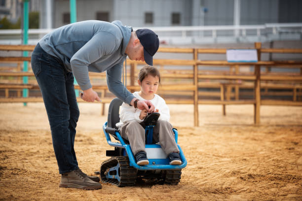 istock Father learns his multiracial daughter how to drive toy car 2199973098
