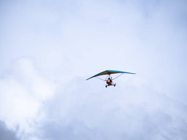 istock Ultralight trike aircraft flying against cloudy sky 2199973304