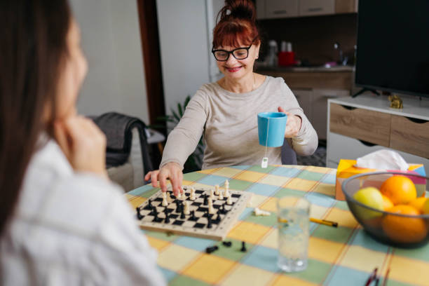 istock Mom and daughter are playing chess 2199975688