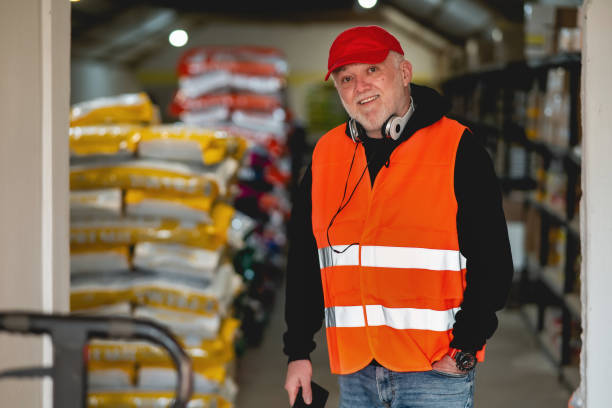 istock An elderly worker in a pet food warehouse cheerfully does his job. 2199979827