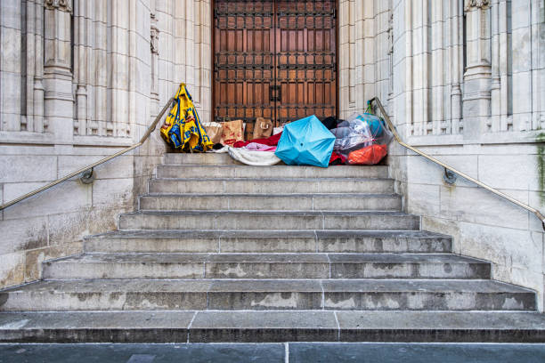 5th Avenue, Manhattan, New York, United States - January 16th 2025:  Homeless person have made a kind of camp on the stairs outside St Thomas Church in the center of New York