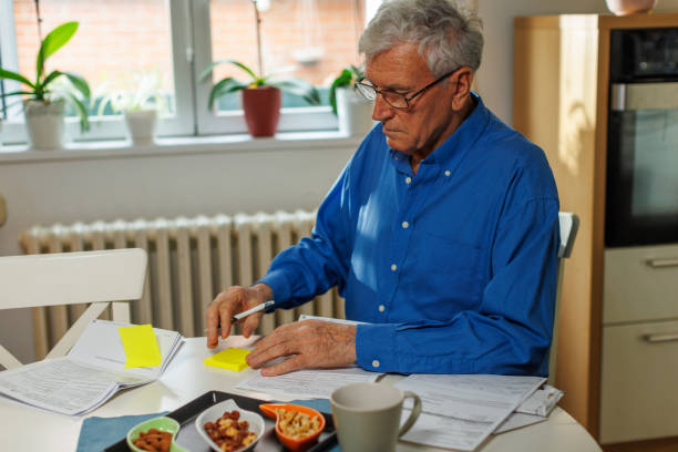 istock 77-Year-Old Man Organizing Bills and Financial Documents 2199983734