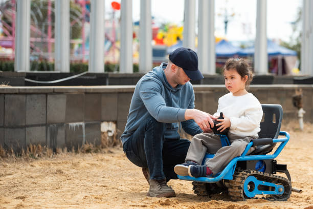 istock Father learns his multiracial daughter how to drive toy car. 2199986502