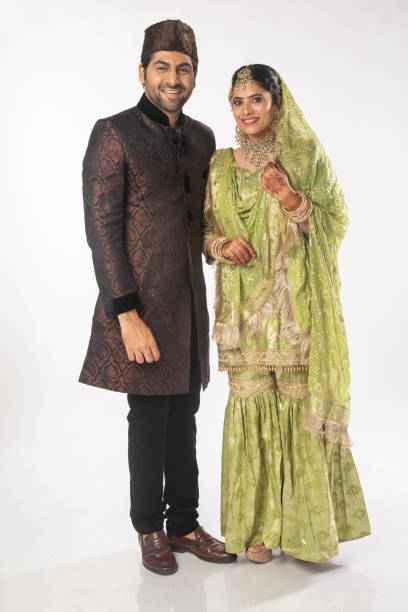 istock Islamic groom and bride standing over white background 2199987016