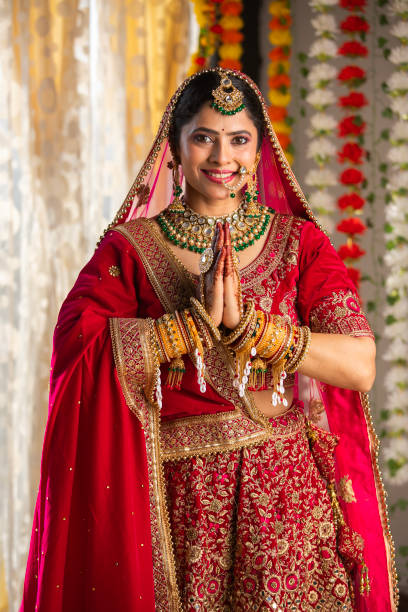 istock Happy bride greeting in prayer pose at wedding ceremony 2199990683