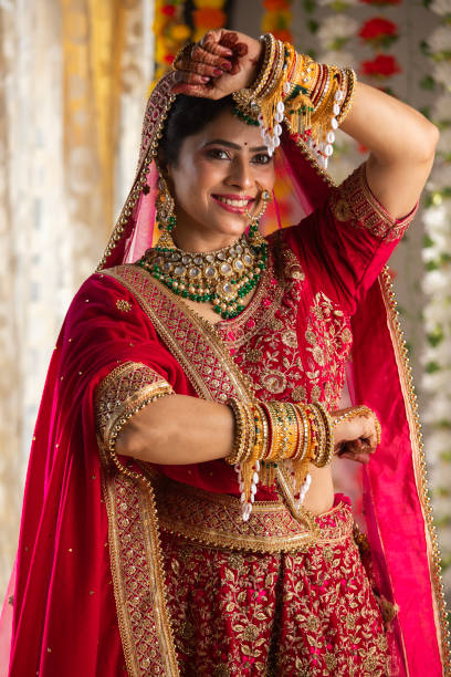 istock Smiling bride in wedding dress showing her bangles 2199990901