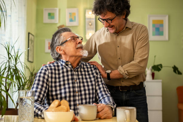 istock Two men enjoying coffee and conversation at home 2199992041