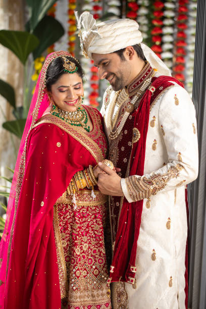 istock Loving groom looking at bride in wedding ceremony 2199992191