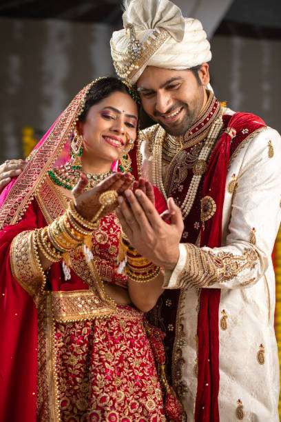 istock Groom looking at bride's hands at wedding ceremony 2199992346