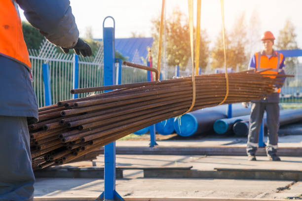 istock Construction workers handling metal rods at outdoor site in daylight 2199992620