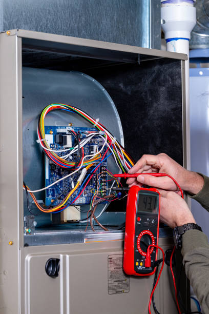istock Master electrician troubleshoots a furnace 2199993892