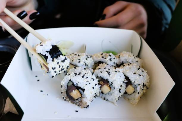Enjoy fresh sushi rolls with a mix of flavors, beautifully presented and topped with black sesame seeds
