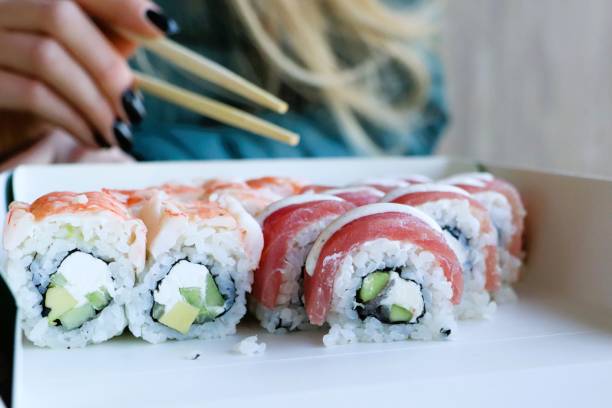 istock Try out these utterly delicious sushi rolls, expertly prepared and served with chopsticks 2199994648
