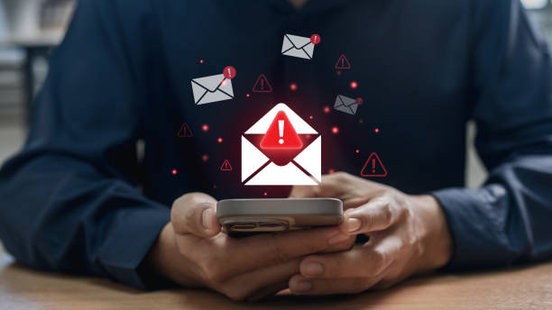 istock Phishing scam and spam email warning concept. office worker checks mobile phone, symbolizing cybersecurity attack threat, alert message and digital safety challenge 2199995068