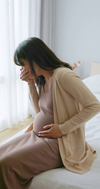 istock asian pregnant woman nausea vomit 2199995431