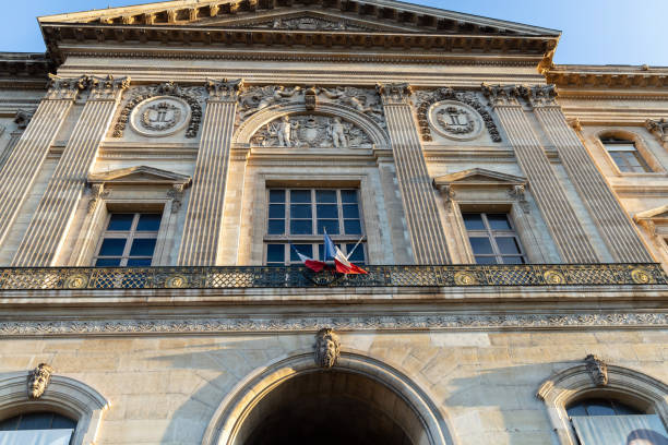 istock Facade of a building with a large window and French flags. 2199995441
