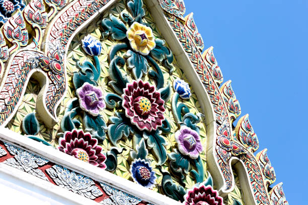 Shot in color detail on the facade of this historic building representing some character, animal or flower. Set at Bangkok, Thailand, Asia