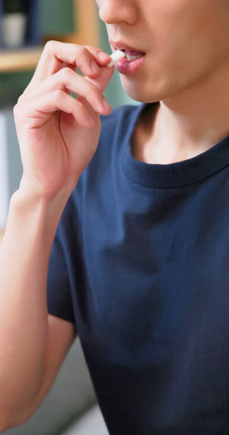 istock Asian man chewing nicotine gum 2199997096
