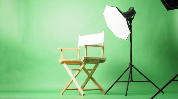 istock A director's chair and professional studio lighting setup in front of a green screen background. 2199997287