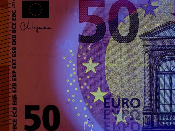 istock Checking banknotes with ultraviolet. Euro currency protected from ultraviolet radiation. Euro in ultraviolet light. 2199998973