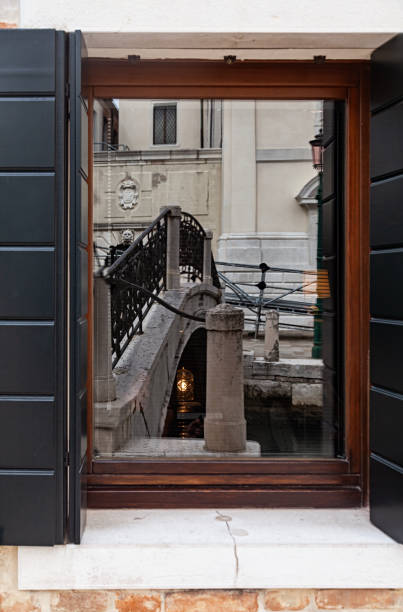 istock Venice bridge (Ponte de la Salute) reflected in window, Venice, Italy. 2200009995