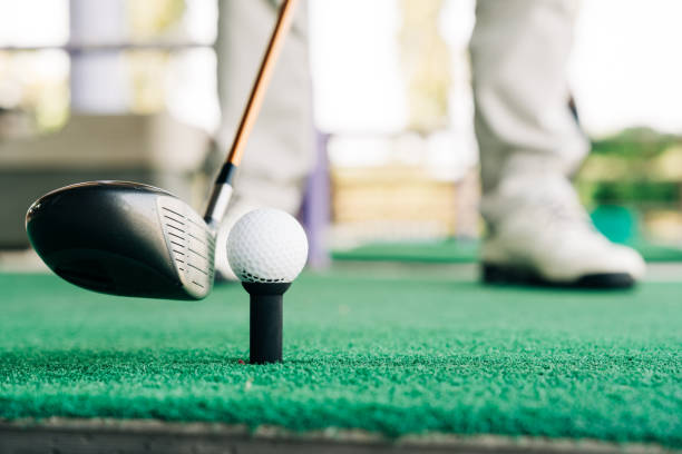 Golfer Preparing to Take a Shot on a Practice Green, Focusing on Precision