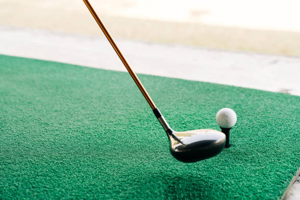 Golfer Preparing to Take a Shot on a Practice Green, Focusing on Precision