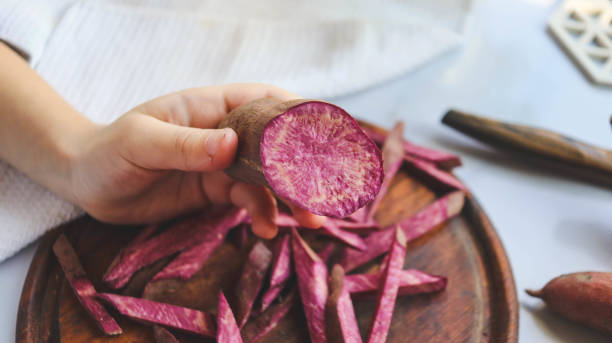 boy cooking sweet potato himself in the kitchen