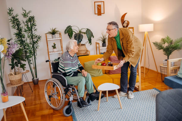 istock Spending time with older woman with disability bringing medicine on tray 2200011100