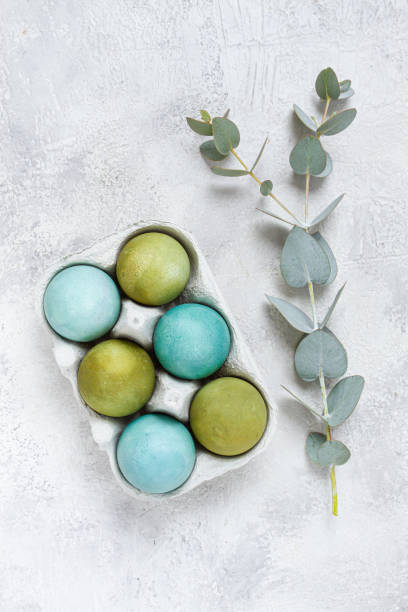 istock Easter colored eggs, in green and turquoise tones, with eucalyptus leaves, Easter card, top view, no people, 2200012440
