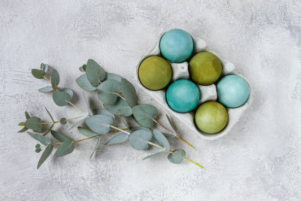 istock Easter colored eggs, in green and turquoise tones, with eucalyptus leaves, Easter card, top view, no people, 2200012708