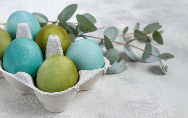 istock Easter colored eggs, in green and turquoise tones, with eucalyptus leaves, Easter card, top view, no people, 2200012936