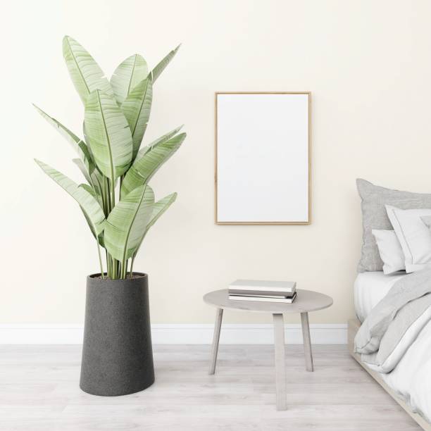 istock Bedroom with vertical frame mockup and interior decoration with bed, ornamental plant and table with books 2200013799